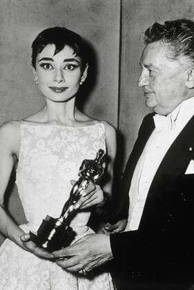 (Archival Classic Cinema - Audrey Hepburn Retrospective) Jean Hersholt presents Audrey Hepburn with an Academy Award for her performance in the film Roman Holiday 1954. Hollywood CA USA  Copyright: xHAx 31569_050CPC