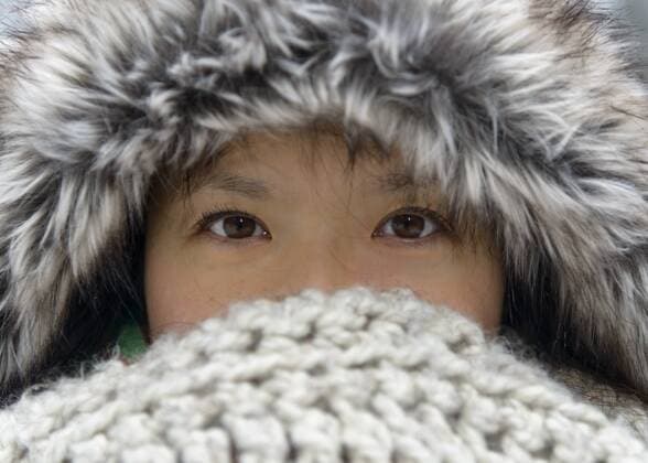Portrait of woman wearing fur cap covering nose and mouth with scarf model released Symbolfoto  TOVF00077
