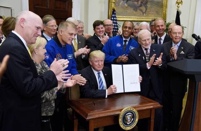 June 30, 2017 - Washington, District of Columbia, United States of America - United States President Donald J. Trump, signs an Executive Order to reestablish the National Space Council as Apollo 11 astronaut Buzz Aldrin (R) looks on in the Roosevelt Room of the White House in Washington, DC, on June 30, 2017..Credit: Pool via CNP Washington United States of America - ZUMAs152 20170630_zaa_s152_066 Copyright: xOlivierxDoulieryx