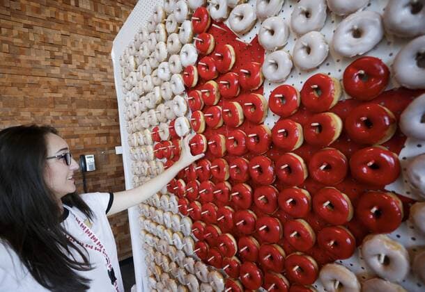 (170702) -- VANCOUVER, July 2, 2017 -- A girl picks a donut from a donut wall in Canadian flag pattern during the Canada Day celebration at Canada Place in Vancouver, Canada, July 1, 2017. People gathered at Canada Place in downtown Vancouver to celebrate the 150th anniversary of Canada on Saturday. ) (zxj) CANADA-VANCOUVER-CANADA DAY-CELEBRATION Liangxsen 