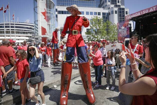 (170702) -- VANCOUVER, July 2, 2017 -- A performer in Royal Canadian Mounted Police costume performs outside Canada Place during the Canada Day celebration in Vancouver, Canada, July 1, 2017. People gathered at Canada Place in downtown Vancouver to celebrate the 150th anniversary of Canada on Saturday. ) (zxj) CANADA-VANCOUVER-CANADA DAY-CELEBRATION Liangxsen 