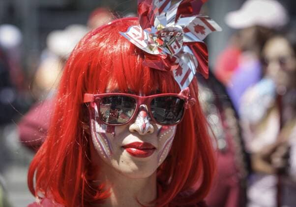 (170702) -- VANCOUVER, July 2, 2017 -- A lady puts on some patriotic decorations during the Canada Day celebration at Canada Place in Vancouver, Canada, July 1, 2017. People gathered at Canada Place in downtown Vancouver to celebrate the 150th anniversary of Canada on Saturday. ) (zxj) CANADA-VANCOUVER-CANADA DAY-CELEBRATION Liangxsen 