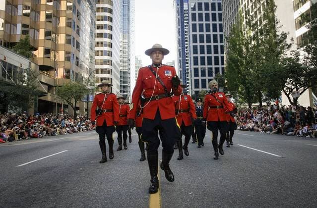(170703) -- VANCOUVER, July 3, 2017 -- Royal Canadian Mounted Police march along the street during the 2017 Canada Day Parade in Vancouver, Canada, July 2, 2017. About 2,000 participants in different traditional costumes participated in this event to celebrate Canada s 150th birthday on Saturday in Vancouver. ) (yy) CANADA-VANCOUVER-150TH CELEBRATION OF CANADA DAY LiangxSen 
