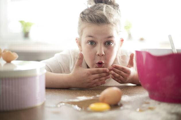Portrait of embarrassed little girl in the kitchen model released Symbolfoto property released  MOEF00042