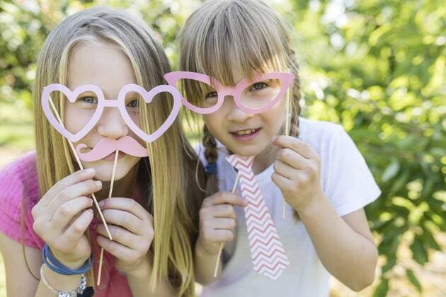 Two playful sisters in garden model released Symbolfoto property released  SHKF00771