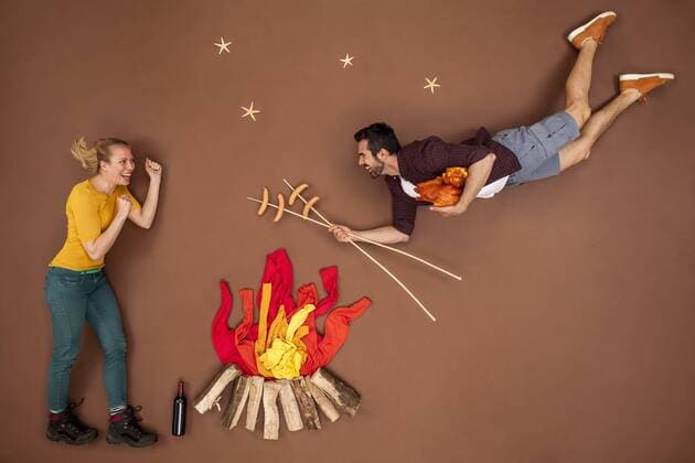 Couple at the campfire roasting sausages model released Symbolfoto  BAEF01422