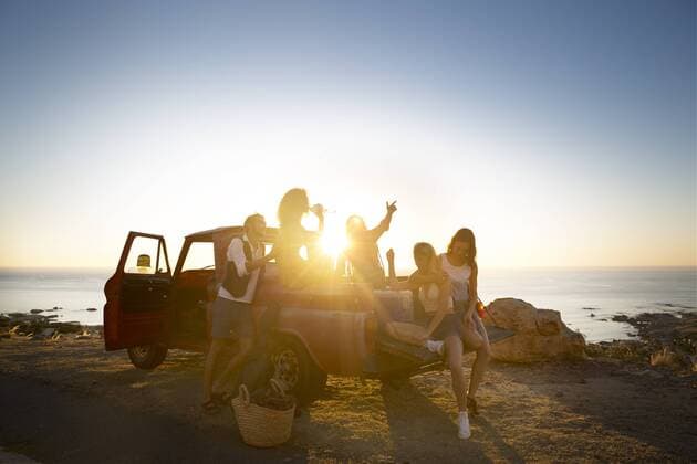 Happy young people outside pick up truck at the coast at sunset model released Symbolfoto property released  ZEF13915