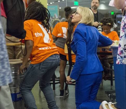 Education Secretary Betsy DeVos kneels as she interacts with students and their science experiments after she and Ivanka Trump read Rosie Revere, Engineer to early grade school children at the Spark Lab at the National Museum of American History in Washington, DC on July 25, 2017. DeVos and Ivanka Trump focused the event on getting girls excited about STEM studies as they participated in certain science experiments.  WAS2017072530 PatxBenic