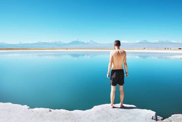 Chile, Atacama Desert, back view of man standing at Laguna Cejar model released Symbolfoto  GEMF01716