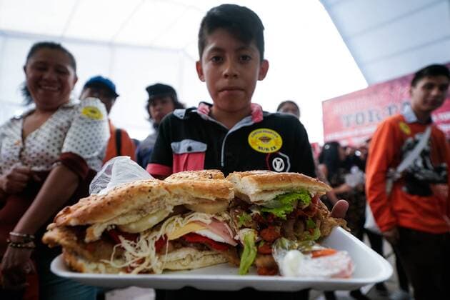 (170727) -- MEXICO CITY, July 27, 2017 -- A boy shows a Mexican traditional sandwich named Torta during the Torta Fair in Mexico City, capital of Mexico, July 26, 2017. According to local press, during the event which is held from July 26 to 30, people made a torta of 67 meters long and 820 kilograms in weight, trying to break the world record of the largest torta. Francisco Canedo) (zy) MEXICO-MEXICO CITY-TORTA FAIR e FranciscoxCanedo 
