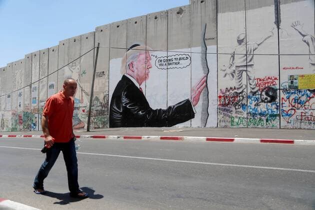 August 6, 2017 - Bethlehem, West Bank, Palestinian Territory - A Palestinian man walks past a graffiti depicting US President Donald Trump on the controversial Israeli separation barrier in the West Bank town of Bethlehem on August 8, 2017 Bethlehem Palestinian Territory - ZUMAap3_ 20170806_zaf_ap3_034 Copyright: xShadixHatemx
