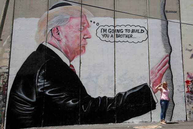 August 6, 2017 - Bethlehem, West Bank, Palestinian Territory - A tourist stand in front of a graffiti depicting US President Donald Trump on the controversial Israeli separation barrier in the West Bank town of Bethlehem on August 8, 2017 Bethlehem Palestinian Territory - ZUMAap3_ 20170806_zaf_ap3_041 Copyright: xShadixHatemx