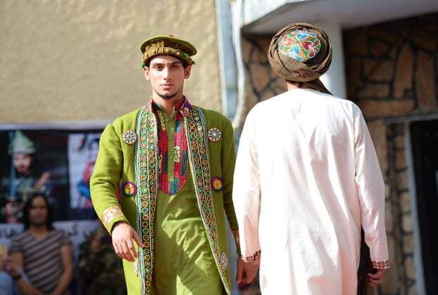 (170811) -- KABUL, Aug. 11, 2017 -- Models present costumes during a fashion show in Kabul, Afghanistan, on Aug. 10, 2017. More than 20 models including six girls attired in colorful dress attended the catwalk ceremony in Kabul on Thursday to display costumes of ethnic people living in Afghanistan. This is the third time that fashion show was held in the conservative society over the past decade, where Taliban-led militancy is continuing. ) (zy) AFGHANISTAN-KABUL-FASHION SHOW DaixHe 