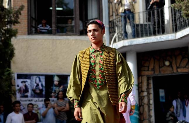 (170811) -- KABUL, Aug. 11, 2017 -- A model presents a costume during a fashion show in Kabul, Afghanistan, on Aug. 10, 2017. More than 20 models including six girls attired in colorful dress attended the catwalk ceremony in Kabul on Thursday to display costumes of ethnic people living in Afghanistan. This is the third time that fashion show was held in the conservative society over the past decade, where Taliban-led militancy is continuing. ) (zy) AFGHANISTAN-KABUL-FASHION SHOW DaixHe 