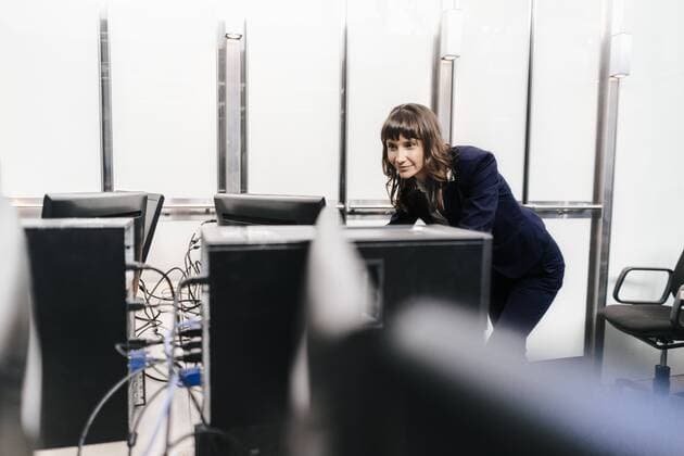 Successful businesswoman looking at monitors in office model released Symbolfoto property released  KNSF02038