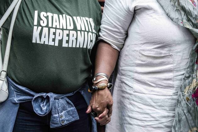 August 23, 2017 - New York City, New York, United States of America - Hand-holding during the moment of silence for Kaepernick and against racism.New Yorkers rallied behind now-unsigned NFL player Colin Kaepernick who has remained seated during the singing of the US National Anthem since 2016. Kaepernick has stated I am not going to stand up to show pride in a flag for a country that oppresses black people and people of color.Ã¢â‚¬Â Kaepernick exercised his free agency option with the San Francisco 49ers and remains unsigned, which some see as a sign of a blacklisting in the NFL. Calls against Verizon were also made due to its 130 million in advertising with the NFL. New York City United States of America - ZUMAb160 20170823_zbp_b160_009 Copyright: xSachellexBabbarx