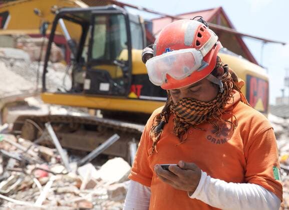 (170910) -- JUCHITAN (MEXICO), Sept. 10, 2017 -- A rescue worker takes a rest at the rescue site after an earthquake hit in Juchitan, Oaxaca state, Mexico, Sept. 9, 2017. A powerful earthquake measuring 8.2 on the Richter scale struck off Mexico s southern coast late Thursday night, killing 90 people. ) MEXICO-OAXACA-JUCHITAN-EARTHQUAKE DanxHang 