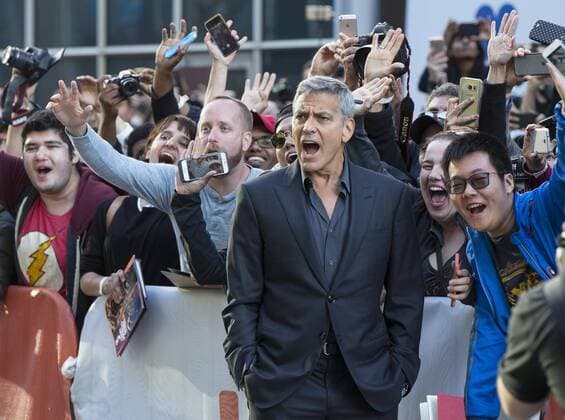 (170910) -- TORONTO, Sept. 10, 2017 -- Director George Clooney (front) poses for photos with fans as he attends the North American premiere of the film Suburbicon at Princess of Wales Theatre during the 2017 Toronto International Film Festival in Toronto, Canada, Sept. 9, 2017. ) (hy) CANADA-TORONTO-TIFF-SUBURBICON ZouxZheng 