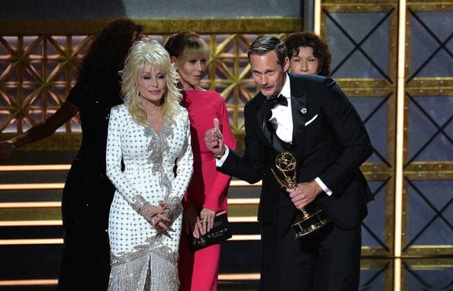 Actor Alexander Skarsgard accepts the award for Outstanding Supporting Actor in a Limited Series or Movie for Big Little Lies from actors Dolly Parton, Jane Fonda and Lily Tomlin, onstage during the 69th annual Primetime Emmy Awards at Microsoft Theater in Los Angeles on September 17, 2017.  LAP201709170155 JIMxRUYMEN