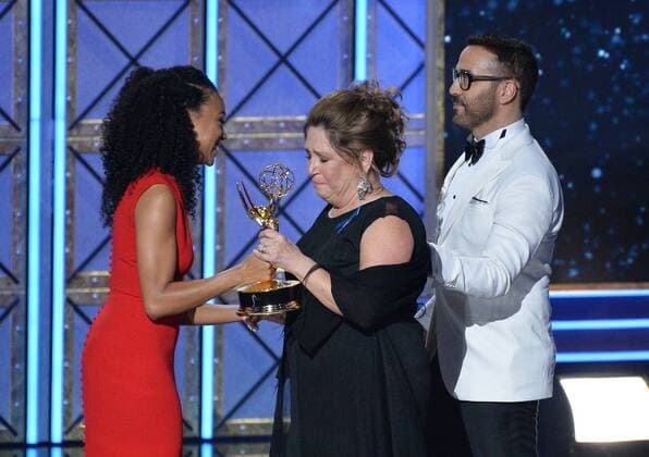 Actor Ann Dowd accepts the award for Outstanding Supporting Actress in a Drama Series for The Handmaid s Tale from actors Sonequa Martin-Green and Jeremy Piven, onstage during the 69th annual Primetime Emmy Awards at Microsoft Theater in Los Angeles on September 17, 2017.  LAP201709170209 JIMxRUYMEN