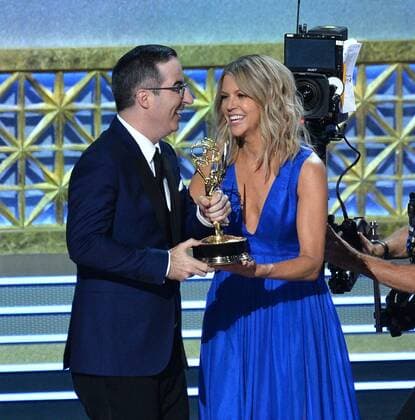 Host John Oliver accepts the award for Outstanding Writing for a Variety Series for Last Week Tonight with John Oliver from actor Kaitlin Olson onstage during the 69th annual Primetime Emmy Awards at Microsoft Theater in Los Angeles on September 17, 2017.  LAP201709170213 JIMxRUYMEN