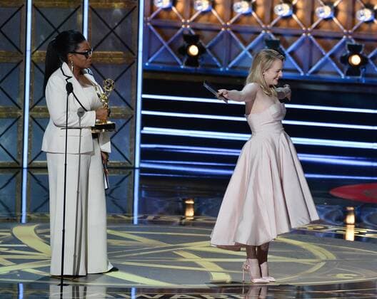Actor Elisabeth Moss accepts the award for Outstanding Drama Series for The Handmaid s Tale from producer-actor Oprah Winfrey, onstage during the 69th annual Primetime Emmy Awards at Microsoft Theater in Los Angeles on September 17, 2017.  LAP201709170221 JIMxRUYMEN