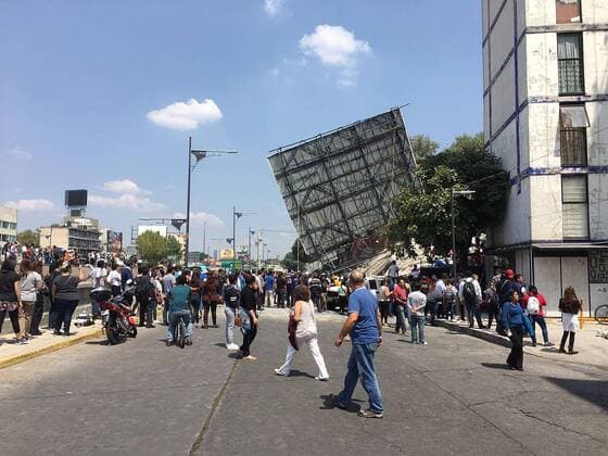 September 19, 2017 - Mexico City, Mexico - A billboards teeters as people walk in the street after a powerful 7.1 earthquake strikes Mexico City collapsing buildings and sending thousands fleeing into streets exactly 32 years after the 1985 devastating earthquake. Mexico MEXICO - ZUMAp124 20170919_zaa_p124_001 Copyright: xArmandoxMenesesx