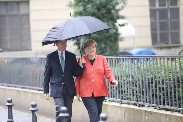 Vote of Chancellor Angela Merkel at the Bundestag Voting by Federal Chancellor Angela Merkel and husband Joachim Sauer at the Bundestag election 2017 at Wahllokal 108, student center Mensa Süd at the Humboldt University of Berlin. Angela Merkel and Joachim Sauer on the way to election-place with umbrella.  SimonexKuhlmey