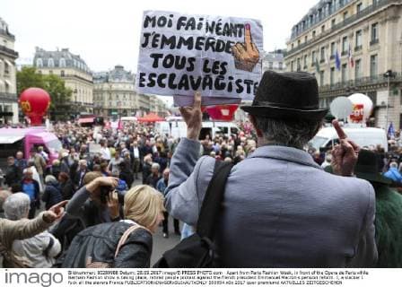 Apart from Paris Fashion Week, in front of the Opera de Paris while Balmain Fashion show is taking place, retired people protest against the french president Emmanuel Macron s pension reform. I, a slacker I fuck all the slavers France  550954
