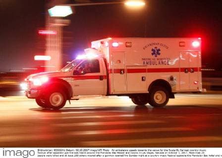 An ambulance speeds towards the venue for the Route 91 Harvest country music festival after apparent gun fire was heard around the Mandalay Bay Resort and Casino in Las Vegas, Nevada on October 1, 2017. More than 20 people were killed and at least 100 others injured after a gunman opened fire Sunday night at a country music festival opposite the Mandalay Bay hotel and resort on the Las Vegas Strip, authorities said.  LAV2017100216 JAMESxATOA