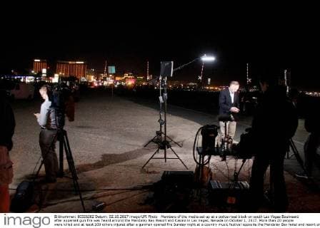 Members of the media set up at a police road block on south Las Vegas Boulveard after apparent gun fire was heard around the Mandalay Bay Resort and Casino in Las Vegas, Nevada on October 1, 2017. More than 20 people were killed and at least 100 others injured after a gunman opened fire Sunday night at a country music festival opposite the Mandalay Bay hotel and resort on the Las Vegas Strip, authorities said.  LAV2017100210 JAMESxATOA