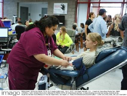 Oct 2, 2017 - Las Vegas, Nevada, U.S. - Creech Air Force Base Master Sgt. ANNA LANSDELL, right, donates blood and is attended by MARIA REYES at United Blood Services. A mass shooting occurred late Sunday evening at the Route 91 Harvest music festival on The Las Vegas Strip. Las Vegas U.S.  - ZUMA 20171002_mda_c98_023 Copyright: xRondaxChurchillx