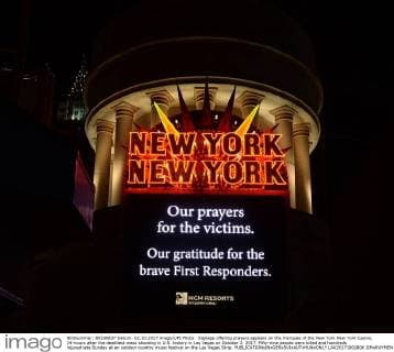 Signage offering prayers appears on the marquee of the New York New York Casino, 24-hours after the deadliest mass shooting in U.S. history in Las Vegas on October 2, 2017. Fifty-nine people were killed and hundreds injured late Sunday at an outdoor country music festival on the Las Vegas Strip.  LAV20171002806 JIMxRUYMEN