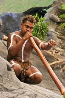 Cairns, Australia, Aborigine man playing a didgeridoo  Copyright: xDanitaDelimont.com