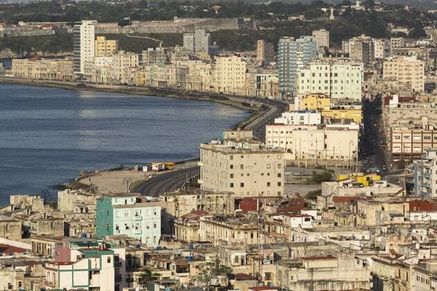 Cuba, Havana. An elevated view of the city skyline showing the bay and Malecon from a hotel rooftop.  Copyright: xDanitaDelimont.com