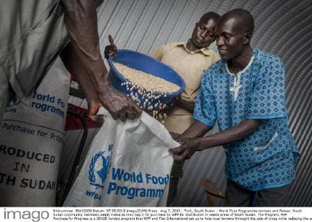 Aug 7, 2015 - Torit, South Sudan - World Food Programme workers and Palwar, South Sudan community members weigh maise as they bag it for purchase by WFP for distribution in needy areas of South Sudan. The Program, P4P Purchase for Progress is a USAID-funded program that WFP and Plan International set up to help local farmers throught the sale of crops while reducing the amount of commodities imported for food aid. Less than normal rains have led to deep concern for the success of the growing season among farmers and WFP officials. Torit South Sudan - ZUMAd90_ 20150807_shd_d90_907 Copyright: xRickxD Eliax