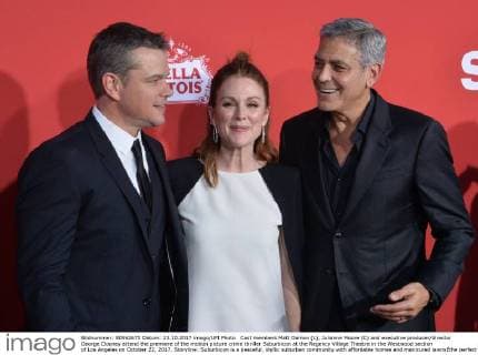 Cast members Matt Damon (L), Julianne Moore (C) and executive producer director George Clooney attend the premiere of the motion picture crime thriller Suburbicon at the Regency Village Theatre in the Westwood section of Los Angeles on October 22, 2017. Storyline: Suburbicon is a peaceful, idyllic suburban community with affordable homes and manicured lawnsÉthe perfect place to raise a family, and in the summer of 1959, the Lodge family is doing just that. But the tranquil surface masks a disturbing reality, as husband and father Gardner Lodge (Matt.Damon) must navigate the townÕs dark underbelly of betrayal, deceit, and violence. This is a tale of.very flawed people making very bad choices. This is Suburbicon.  LAP2017102244 JIMxRUYMEN