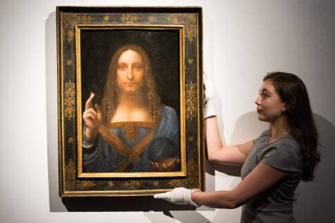 October 24, 2017 - London, London, UK - London, UK. A Christie s staff member holds a painting titled Salvator Mundi (1490) by artist Leonardo da Vinci with an estimate in excess of 00 million. The painting of Christ as Salvator Mundi was recently attributed to Leonardo da Vinci, who is known to have painted the subject. It was lost and later rediscovered, and restored and exhibited in 2011. London UK  - ZUMAl94_ 20171024_zaf_l94_009 Copyright: xRayxTangx