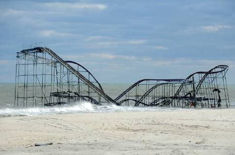 A photo taken in the first week after Hurricane Sandy struck shows the devastated Seaside Heights boardwalk with its rollercoaster submerged in the Atlantic Ocean. It has been five years since Hurricane Sandy hit New York City on October 29, 2012, bringing with it unprecedented storm surges and flooding that devastated many communities throughout the five boroughs. Since the storm many homes are still being rebuilt.  NYP20171027901 DENNISxVANxTINE