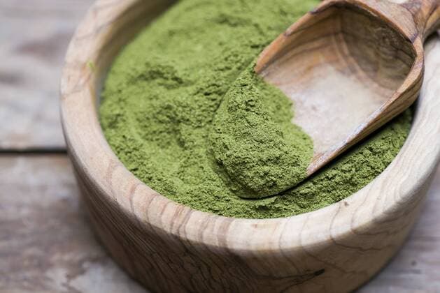 Wooden bowl of organic Moringa powder  CZF00308
