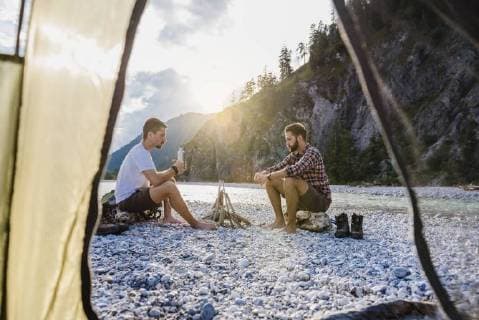 Germany, Bavaria, two hikers camping on gravel bank in the evening model released Symbolfoto  DIGF02831