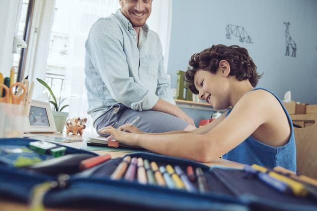 Father helping boy doing his schoolwork at home model released Symbolfoto property released  MFF03719