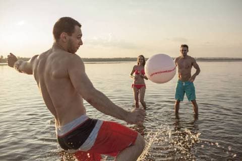 Happy friends playing with a ball in water model released Symbolfoto  VPIF00012
