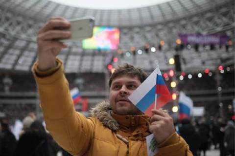 MOSCOW, RUSSIA - NOVEMBER 4, 2017: A man takes a selfie with the Russian flag ahead of a concert titled Russia Unites! marking Russia s National Unity Day at Moscow s Luzhniki Stadium. Sergei Bobylev TASS  TS067CA6