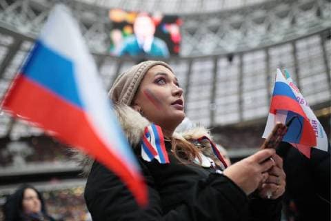 MOSCOW, RUSSIA - NOVEMBER 4, 2017: People hold the Russian flags ahead of a concert titled Russia Unites! marking Russia s National Unity Day at Moscow s Luzhniki Stadium. Sergei Bobylev TASS  TS067CF2