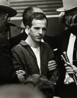 Guards and secret service agents escorting Lee Harvey Oswald through the Dallas police headquarters two days after his arrest in conjunction with the assassination of President Kennedy. Oswald was shot by local night club owner Jack Ruby shortly after this photograph was taken. November 24, 1963, Dallas, Texas  1003_780THA
