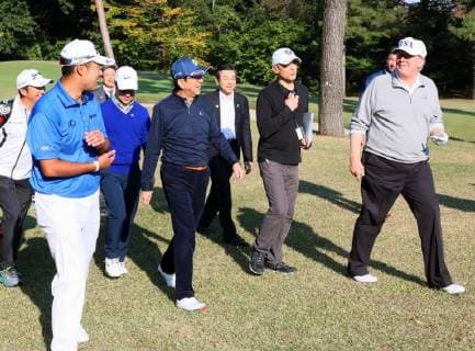 Trump in Japan U.S. President Donald Trump (R), Japanese Prime Minister Shinzo Abe (C, blue hat) and professional golfer Hideki Matsuyama walk at Kasumigaseki Country Club in Kawagoe, Saitama Prefecture, on Nov. 5, 2017. Abe and Trump played the sport a day before their formal talks in Tokyo. (Photo courtesy of the Cabinet Public Relations Office) 