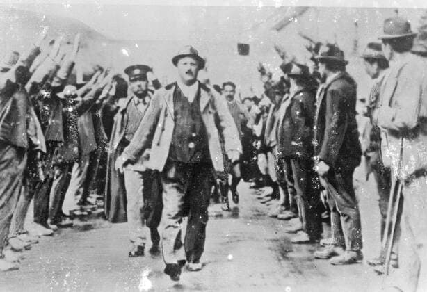 Germany says Austria is really Nazi . A secret picture to prove it . The caption to this picture , just received in London from Germany , says that it illustrates the true feeling of the population of Austria , tyrannised as it is by a small minority . The photograph was made secretly at Cmuend in Carithia when a farmer was arrested by the Austrian police for having carried on Nazi agitation . He was led away to the accompaniment of cheers and a forest of arms raised in the fascist salute . Photo shows , the farmer being led away by the police as the people of Gmuend give the Nazi salute , a picture taken secretly and smuggled out of Austria . 11 January 1934, Austria Copyright: Topfoto  UnitedArchivesEU035876
