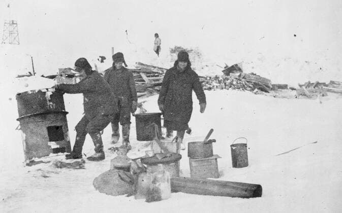 SS Chelyuskin , a Soviet steamship sent out on an expedition to navigate through polar ice along the Northern Maritime Route from Murmansk to Vladivostok , has became ice-bound in Arctic waters during navigation . It was caught in the ice fields in September. After that it drifted in the ice pack before sinking on February 13 , 1934, crushed by the icepacks near Kolyuchin Island in the Chukchi Sea . The crew managed to escape onto the ice and built a makeshift airstrip using only a few spades , ice shovels and two crowbars , which helped in the rescue of the crew . Fifty three men walked over the ice with stores on husky sleds . Photo shows ; Members of the expedition trying clear up the destroyed Schmidt camp 24 March 1934, Russia Federation Copyright: Topfoto  UnitedArchivesEU038090