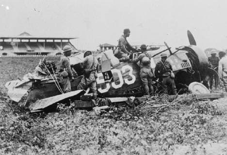 Delighted Japanese soldiers inspecting the wreckage of a Chinese warplane which was brought down by the forces at the racecourse and polo grounds near the Civic Centre at Shanghai.. 4 October 1937., Japan Copyright: Topfoto  UnitedArchivesEU051154